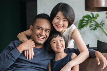 Happy Asian family using the computer together at home