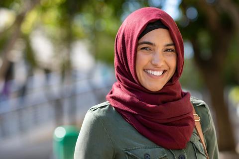 Smiling woman in a hijab looking at the camera