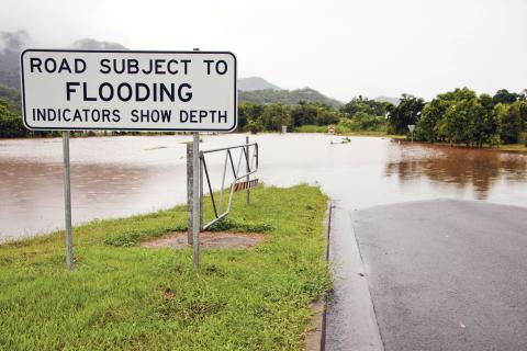 Flooded road with signage in NSW