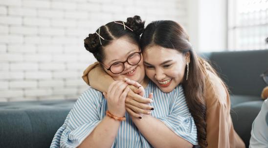 Two females hugging