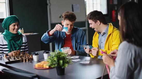 Group of people playing cards and laughing