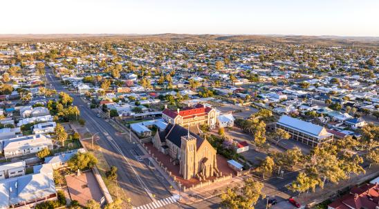 Early morning sunrise high angle aerial drone view of the Cathedral of the Sacred Heart of Jesus, a catholic church, and the historic outback mining town of Broken Hill, New South Wales, Australia.